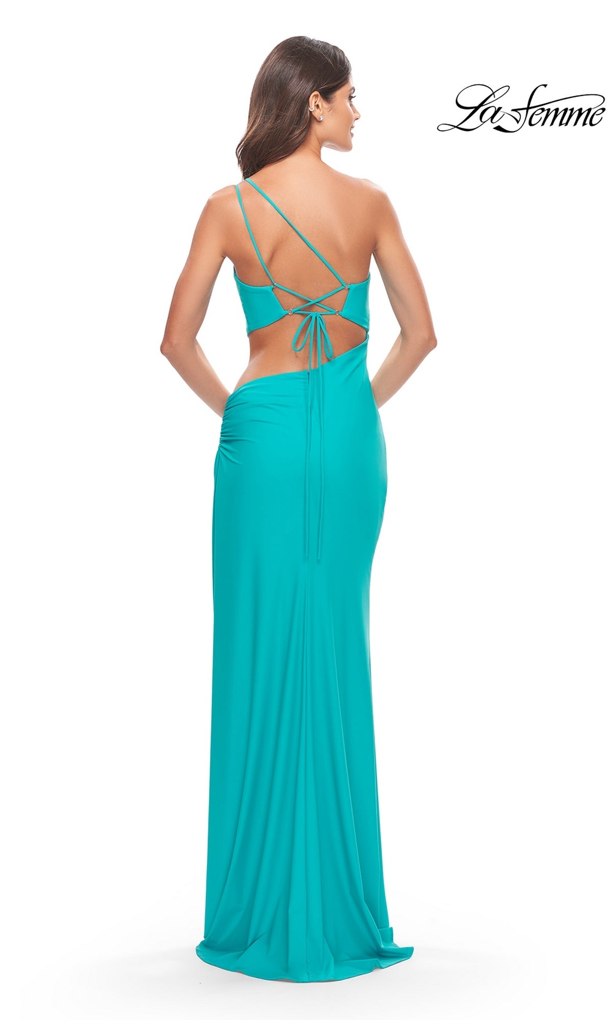 A woman faces away from the camera in the La Femme Long Prom Dress 31443, a bright turquoise fitted gown with thin crisscross straps. The La Femme logo appears in the top right corner.